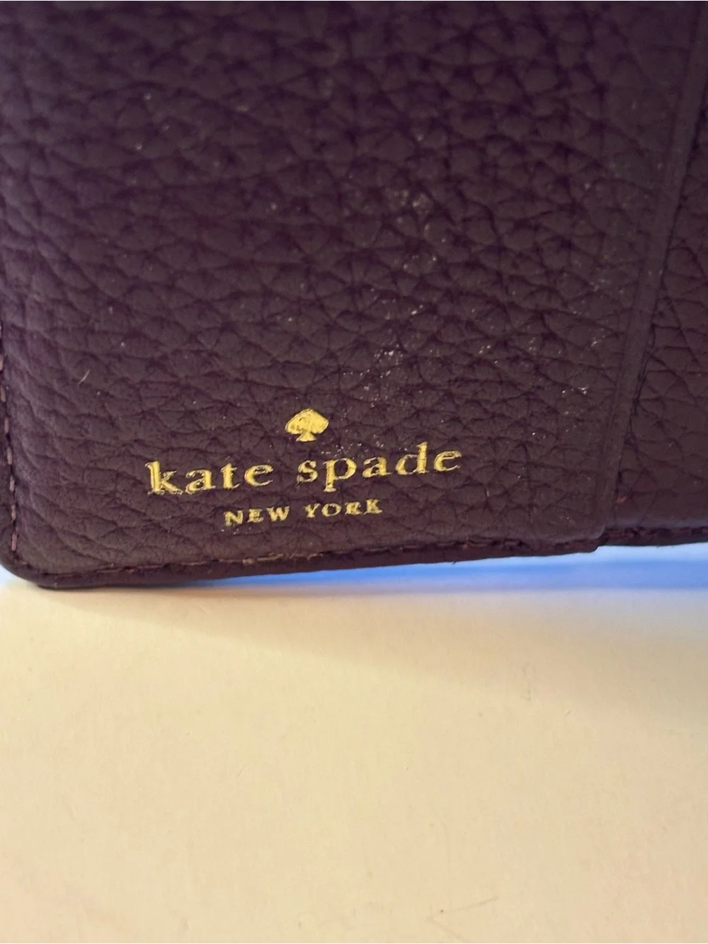 kate spade plum pebbled leather trifold wallet with gold logo